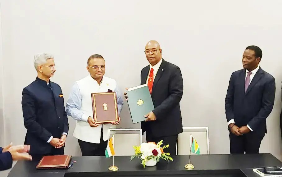 Minister of Public Works Juan Edghill (second from right) and High Commissioner of India to Guyana Dr. K.J. Srinivasa (third from right) with the agreement. At right is Guyana’s Minister of Foreign Affairs Hugh Todd. Indian Minister of External Affairs Dr. Subrahmanyam Jaishankar is at left. (GCAA photo)