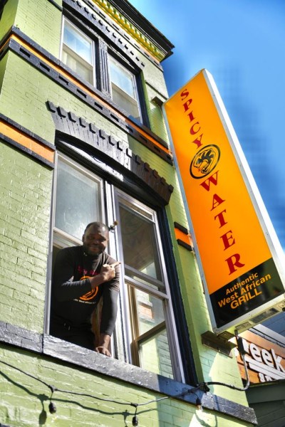 Duraine Kouassi, owner of Spicy Water African Grill, at his colorful restaurant at 2019 11th Street NW, a few steps from U Street (Courtesy of Spicy Water)