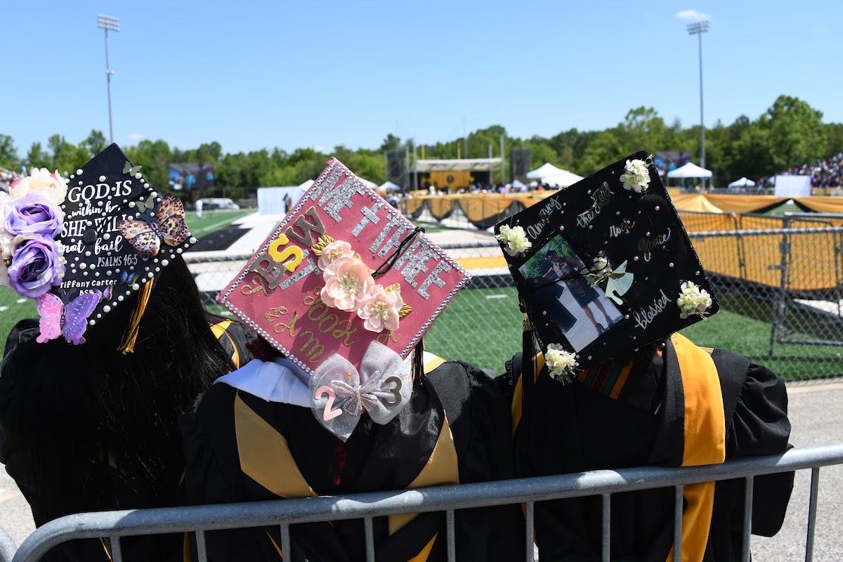 A trio of graduates adorned their caps with decorations for the commencement ceremony at Bowie State University on May 26. (Anthony Tilghman/The Washington Informer)