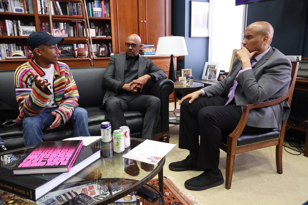 From left: Thirteen-time Grammy winner Pharrell Williams, Harvey Mason Jr., CEO of the Recording Academy, and Sen. Cory Booker (D-New Jersey) met during Grammys on the Hill Advocacy Day on April 27. (Courtesy Photo, Recording Academy/Paul Morigi for Getty Images)