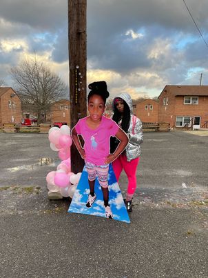 Donnetta Wilson, the mother of the late Makiyah Wilson, stands next to a cutout board figure of the child who was murdered on July 16, 2018, in the Clay Terrace community in Northeast. The D.C. Council approved a resolution that ceremoniously designates the 300 block of 53rd Street in Northeast as "Makiyah Wilson Way." (Courtesy photo)
