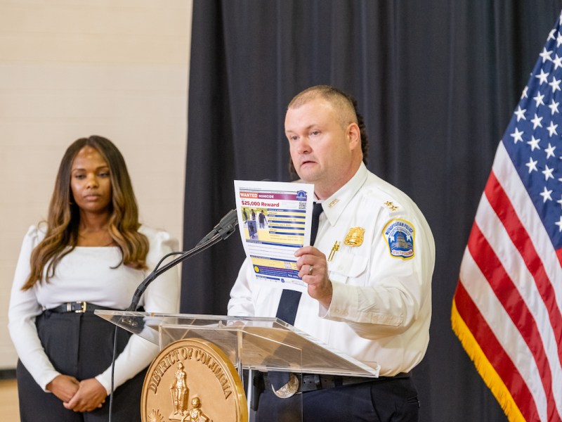 Leslie Parsons, assistant chief of the Investigative Services Bureau at the Metropolitan Police Department, holds up a wanted poster for some of the recent crimes in the the District of Columbia. (Ja'Mon Jackson/The Washington Informer)
