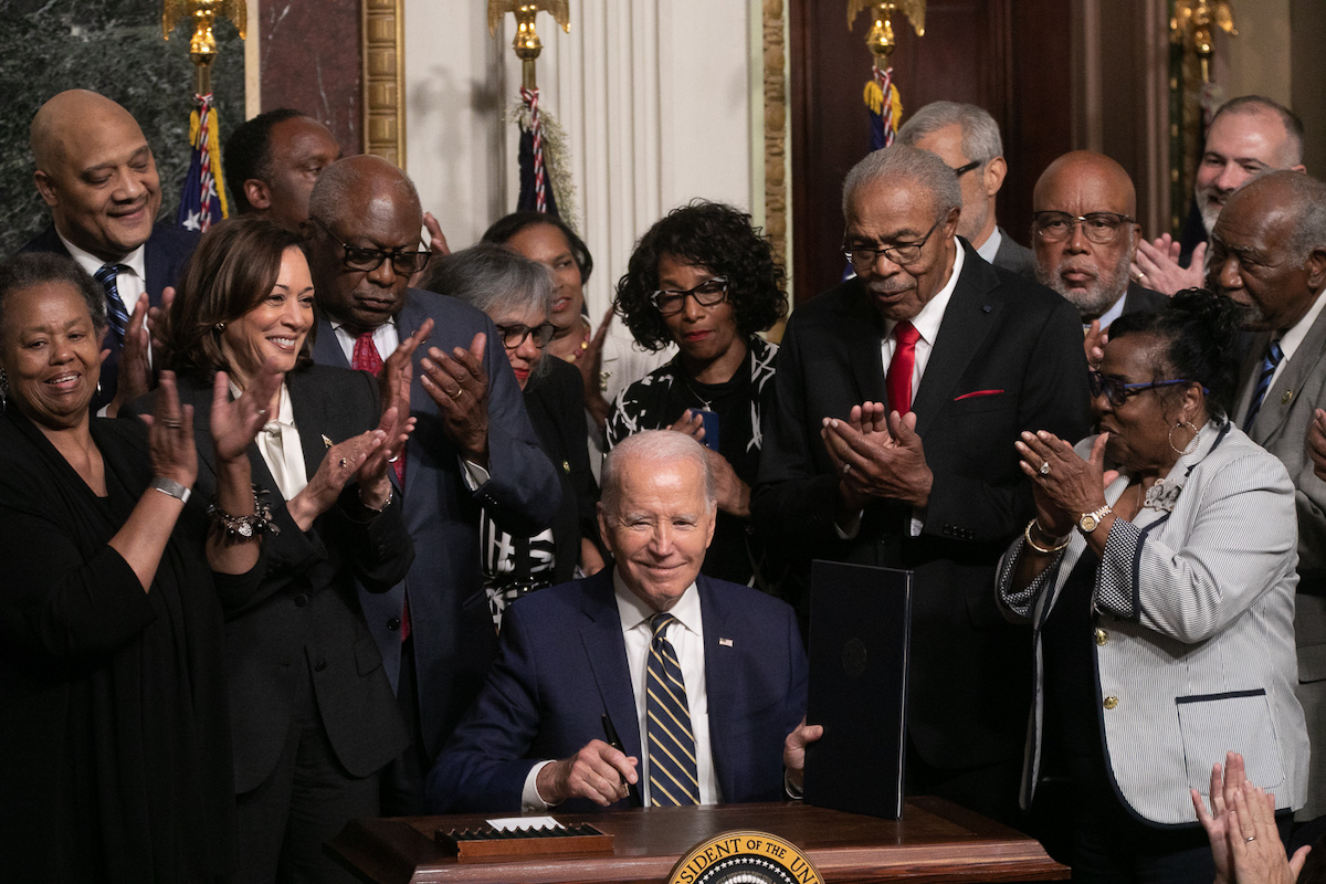 President Joe Biden signs a proclamation at the White House on July 25 designating a national monument spanning two states to memorialize Emmett Till and his mother, Mamie Till-Bradley. (Courtesy of Mark Mahoney)