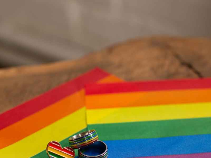 close up photo of rings on pride flag