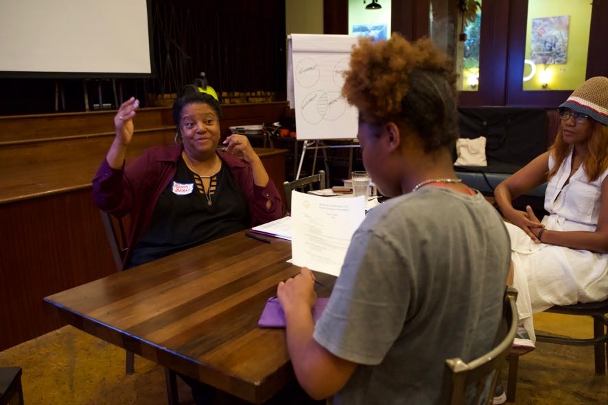 College counseling professional Tonda Bean (left) coaches Otisha Richards on time management during the Summer Empowerment Camp for the Future Diamonds of Southeast Washington DC at Busboys and Poets in Anacostia, held from Aug. 14-18.