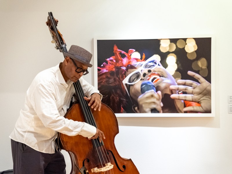 Double bass master Herman Burney performs before Frank Stewart's portrait of award-winning jazz vocalist Cécile Salvant McLorin at “Phillips After 5: All That Jazz,” a collaboration between The Phillips Collection and DC JazzFest. (Ja’Mon Jackson/The Washington Informer)