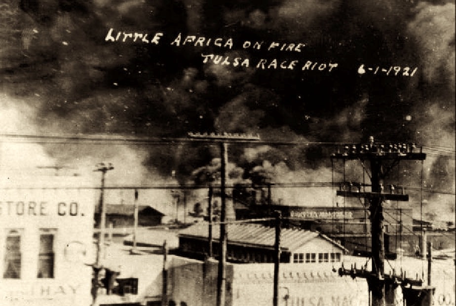 In this postcard from the collection of McFarlin Library at the University of Tulsa, a photo from on top of the Santa Fe Freight office at 1st Street and Elgin Avenue in Tulsa, Oklahoma, is seen, showing the fires on Archer towards Greenwood. The Goodner-Malone company (1 N. Frankfurt) building is in the center of the photo. (Courtesy of Wikimedia Commons)