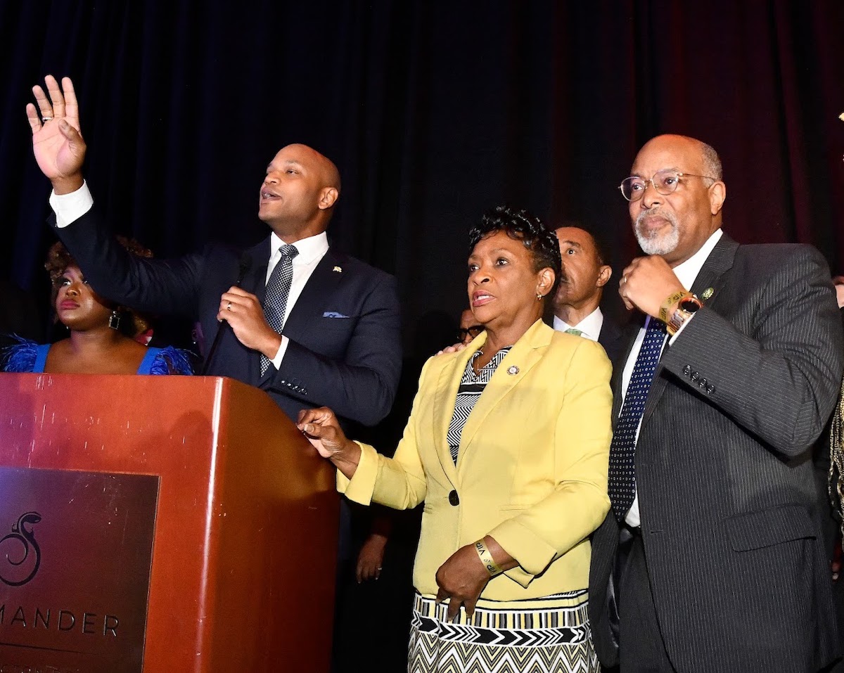 Maryland Gov. Wes Moore (at podium) addresses the crowd alongside Lt. Gov. Aruna Miller, Maryland Reps. Kweisi Mfume and Glenn Ivey, and Black Caucus Chair Jheanelle Wilkins. (Robert R. Roberts/The Washington Informer)
