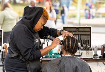 Planning is extensive and includes every little detail: A local barber gives free haircuts to D.C. residents at the annual CBC Spouses Community Breakfast and Health Fair.