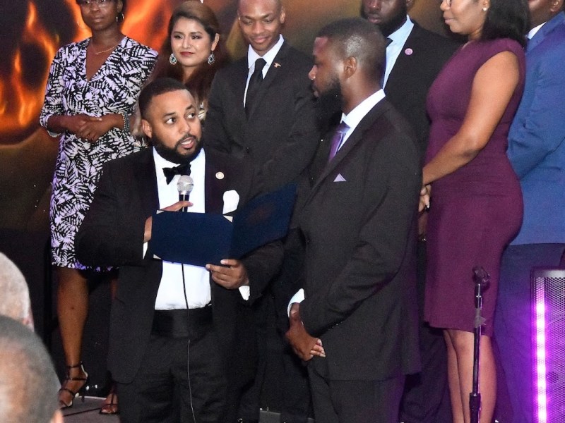 Prince George's County Delegation Chair Del. Nick Charles (holding microphone) receives a community service award from the Young Democrats. The Executive Board stands behind Charles. (Robert R. Roberts/The Washington Informer)