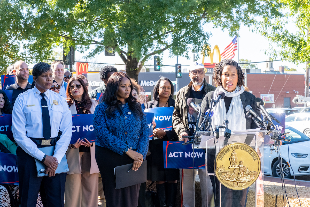 D.C. Mayor Muriel Bowser announces the Addressing Crime Trends (ACT) Now Act at the Metropolitan Police Department’s Fourth District Station on Oct. 23 along with acting Chief of Police Pamela A. Smith (front, far left) and Deputy Mayor for Public Safety and Justice Lindsey Appiah (front center). (Ja’Mon Jackson/The Washington Informer)