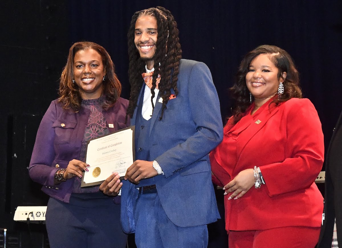 ONSE Pathways Program Interim Director Kwelli D. Sneed, Dalonta Crudup and ONSE Program Manage Mishawn Freeman pose at the Pathways Program’s 14th graduation Ceremony on Sept. 29. (Robert R. Roberts/The Washington Informer)