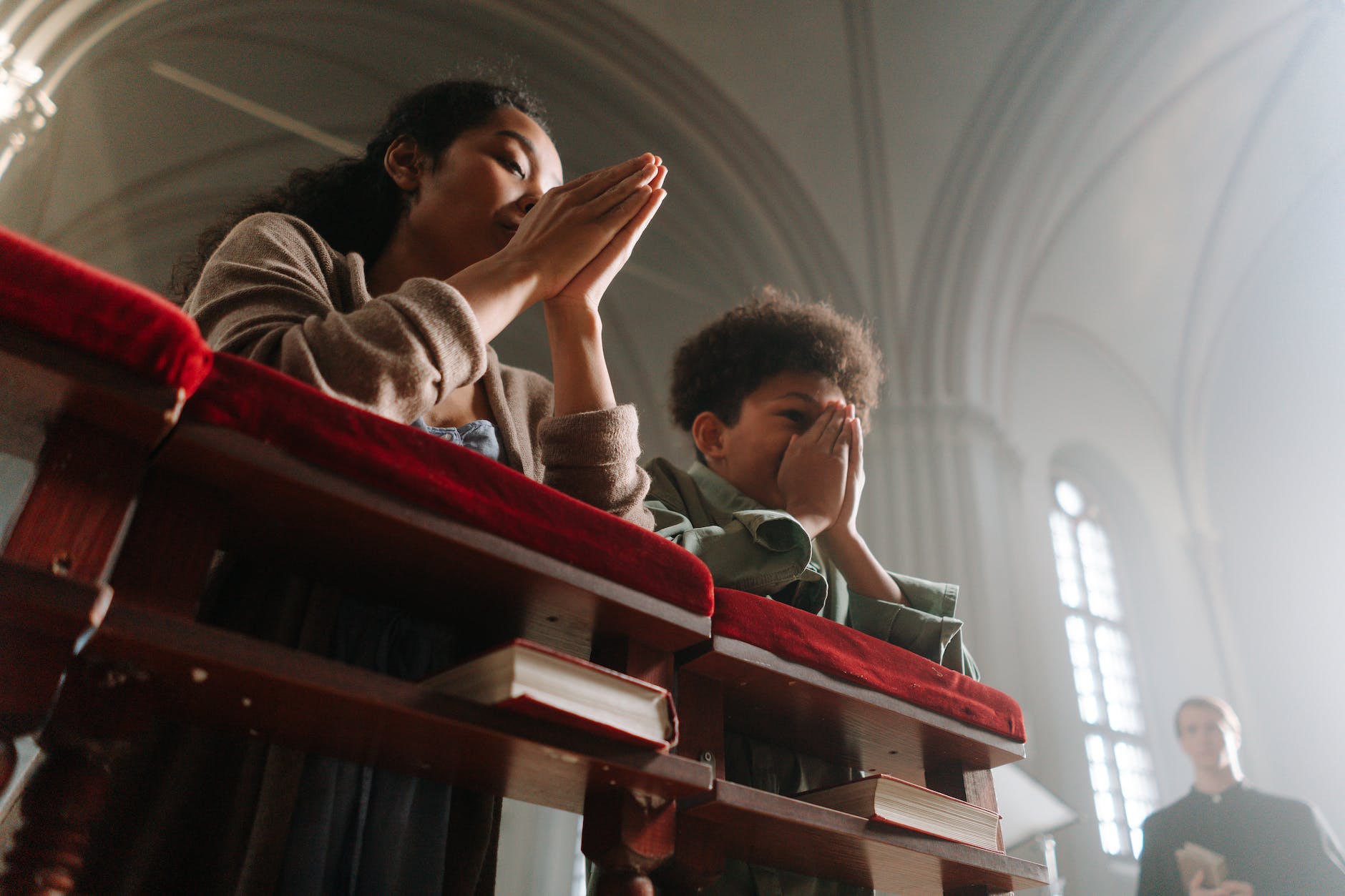 mother and son praying together