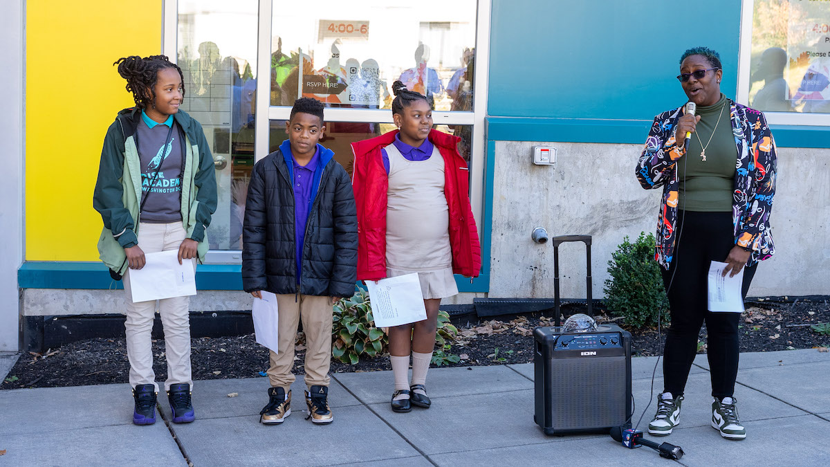 Chasity Thurston, Armani Green and River Jones stand in front of Rocketship Rise Academy on Raynolds Place SE in D.C. on Nov. 14 and read monologues they prepared under the tutelage of Britney Ayala, their arts and drama teacher. Each monologue touched on themes of violence and how young people use their voices to compel change. (Courtesy of Glen Gordon Jr.)