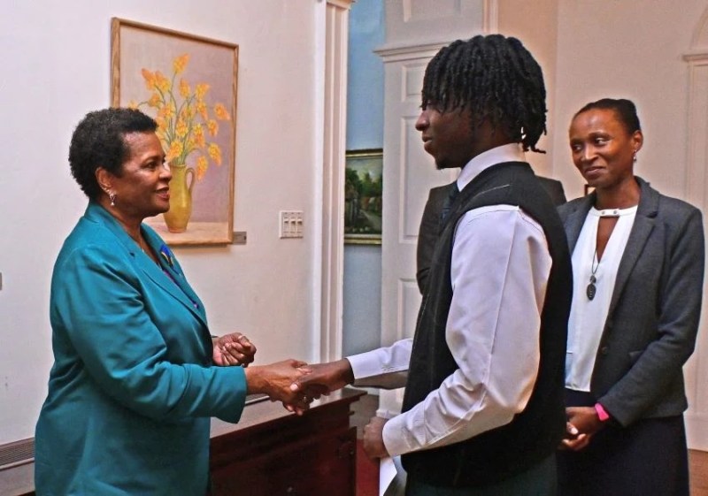 President of Barbados Dame Sandra Mason congratulates Jervon Sands, the 2024 Rhodes Scholar for the Commonwealth Caribbean. Looking on is Bertha Pilgrim, Secretary of the Commonwealth Caribbean Rhodes Scholarship Selection Committee.