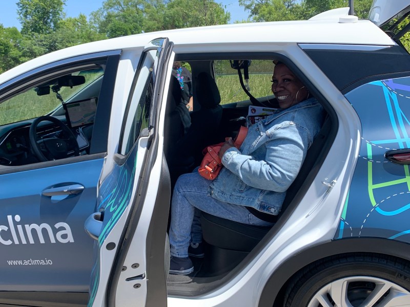 Ivy City Advisory Neighborhood Commissioner Sebrena Rhodes climbs into a car equipped with specialty air quality sensors for a ride-along following the official launch of a hyperlocal air quality monitoring pilot program in June. (Kayla Benjamin/The Washington Informer)