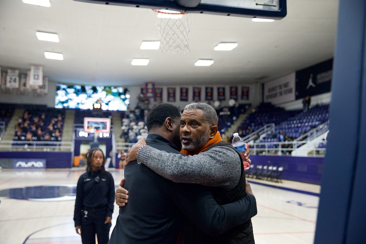 Todd Bozeman, father of slain son, Blake Bozeman, embraces Howard head basketball coach Kenneth Blakeney during game. (Courtesy of an Penny)