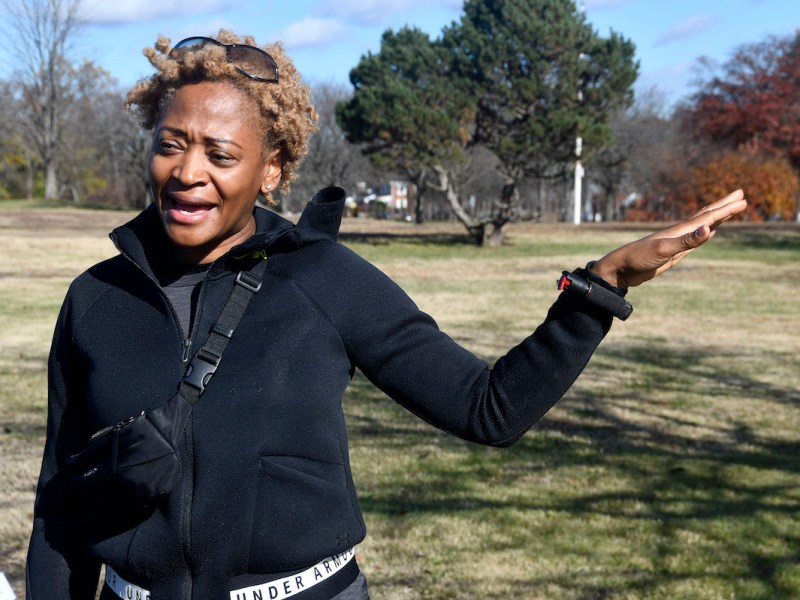 Junel Jeffrey, president of the Eastland Gardens Civic Association, speaks about the testing kiosk while standing at the site Nov. 22. She walks past the spot each day with her dog, Selah V. (Robert R. Roberts/The Washington Informer)