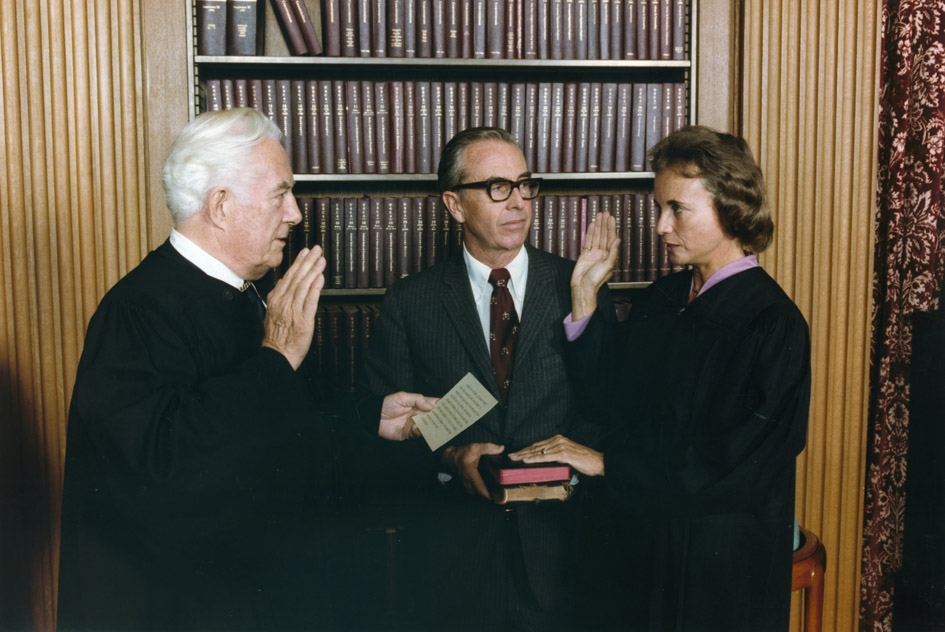 Sandra Day O'Connor is sworn in as a Supreme Court justice by Chief Justice Warren Burger as her husband John O'Connor watches on Sept. 25, 1981. (National Archives and Records Administration via Wikimedia Commons)