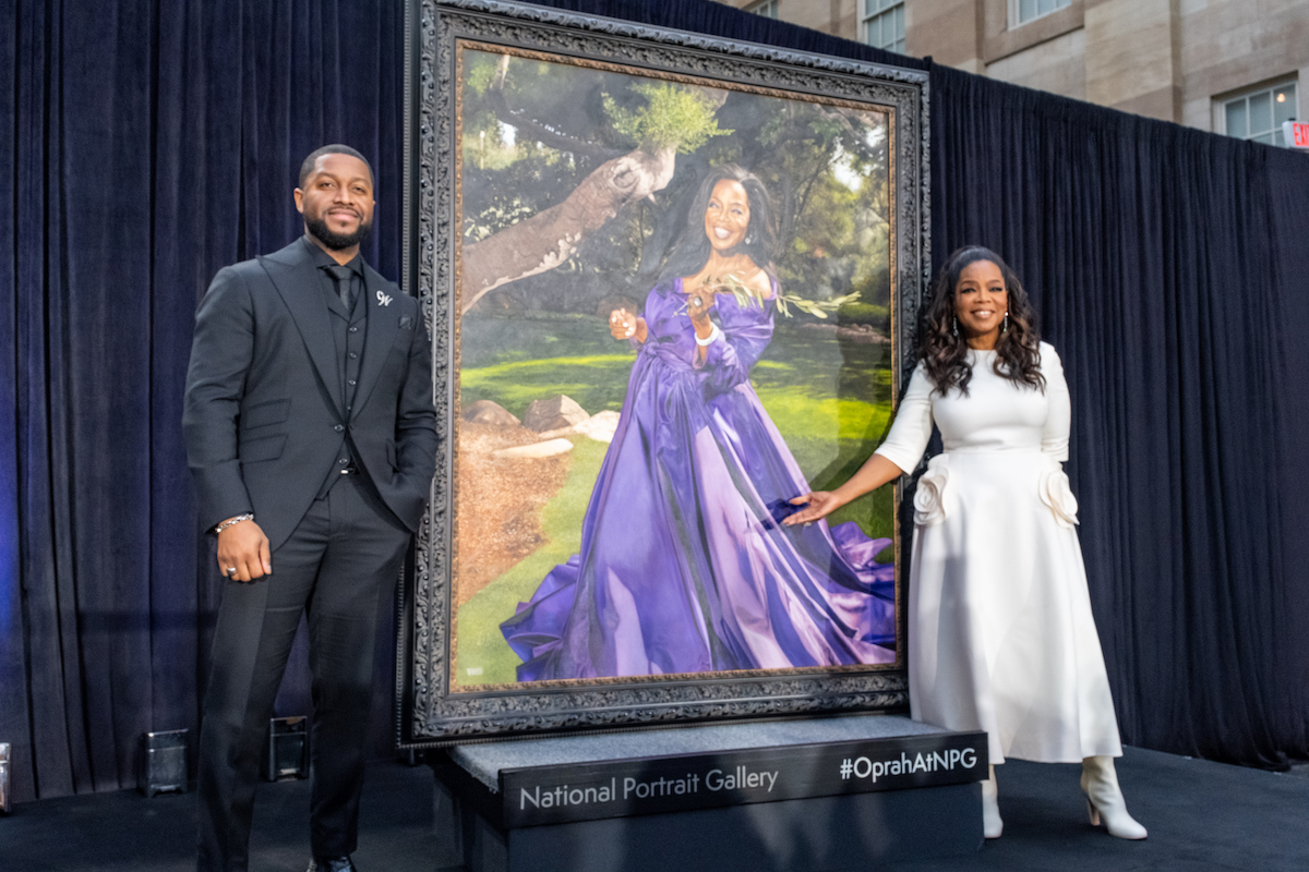 Media mogul Oprah Winfrey (right) stands beside a newly commissioned portrait of herself that unveiled at the National Portrait Gallery on Dec. 13, along with Chicago-based artist Shawn Michael Warren, who painted the portrait. (Ja’Mon Jackson/The Washington Informer)