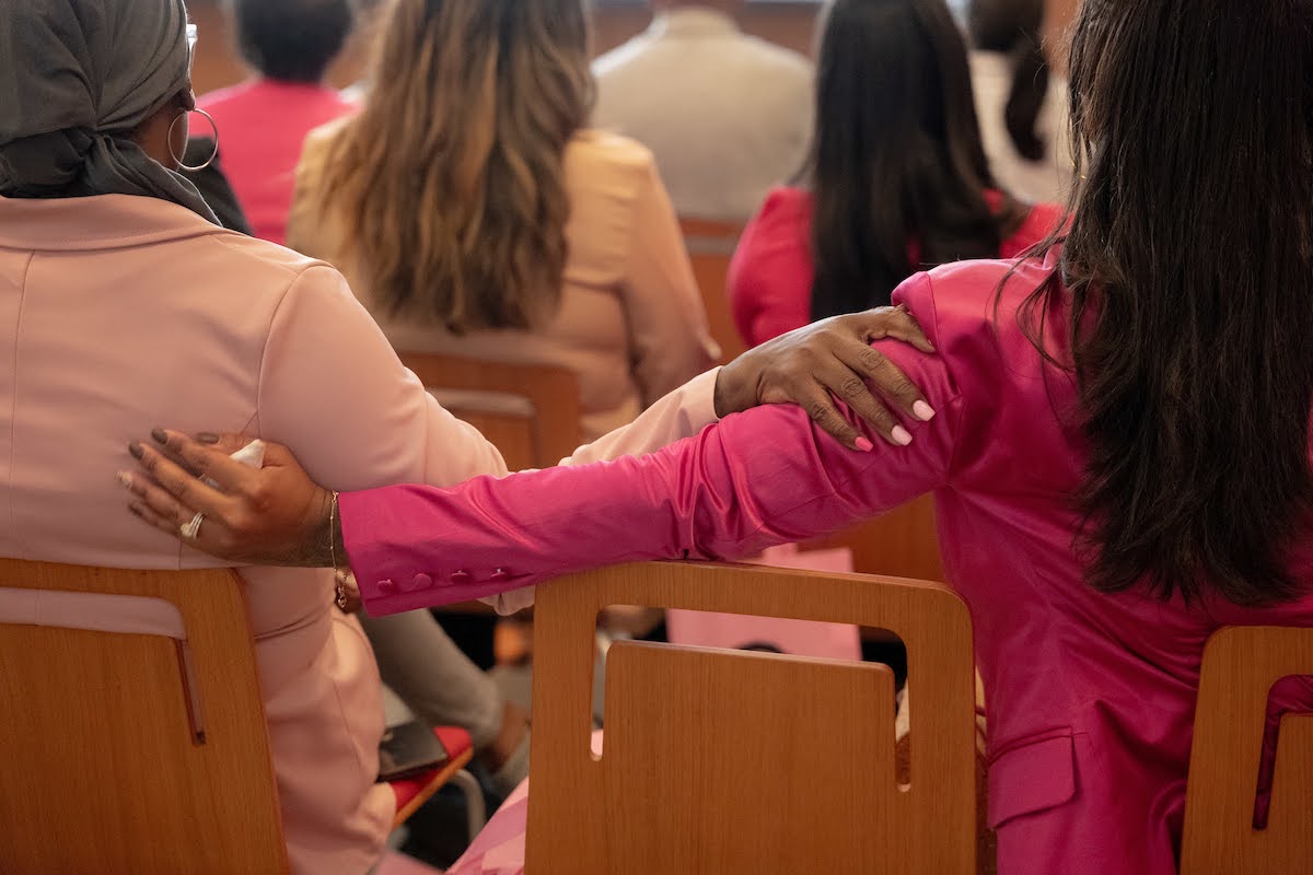 Two audience members hold each other during a screening of the film "A Letter to my Sisters," a documentary produced by Nia Imani Bailey about young women and breast cancer, in Philadelphia on Oct. 7, 2023. (Caroline Gutman/Inside Climate News)