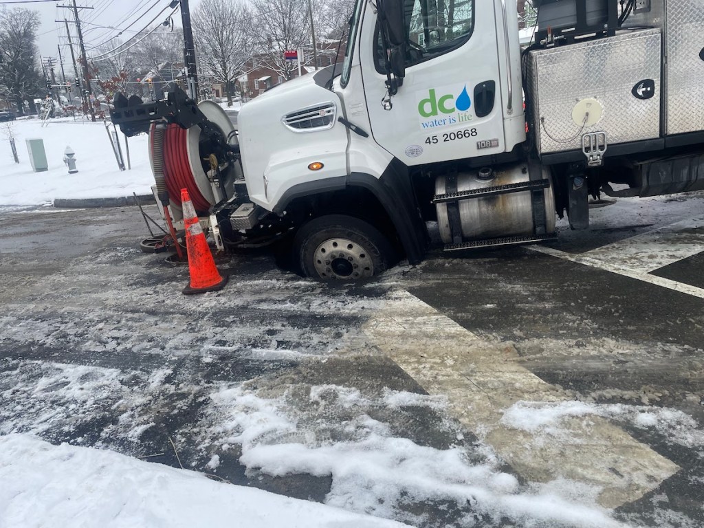 When a huge DC Water truck first arrived on the scene on the morning of Jan. 16, it fell into the hole left in the road by the collapsed sewage pipe. (Courtesy of Kayla Smith)