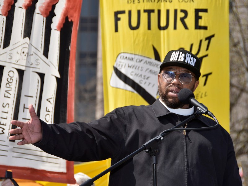 The Rev. Lennox Yearwood Jr., president of the Hip Hop Caucus, rallies the crowd at a demonstration against major banks' fossil fuel investment in downtown D.C. in March 2023. (Robert R. Roberts/The Washington Informer)