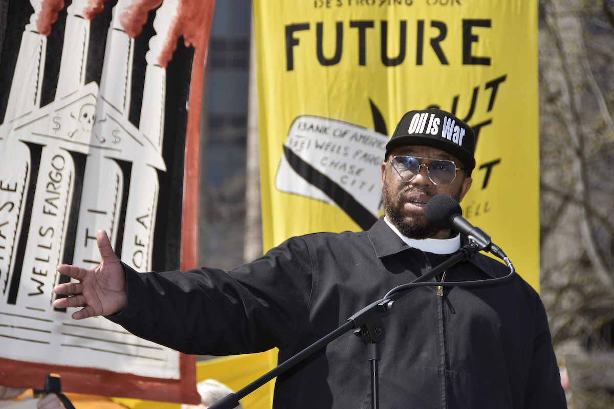 The Rev. Lennox Yearwood Jr., president of the Hip Hop Caucus, rallies the crowd at a demonstration against major banks' fossil fuel investment in downtown D.C. in March 2023. (Robert R. Roberts/The Washington Informer)