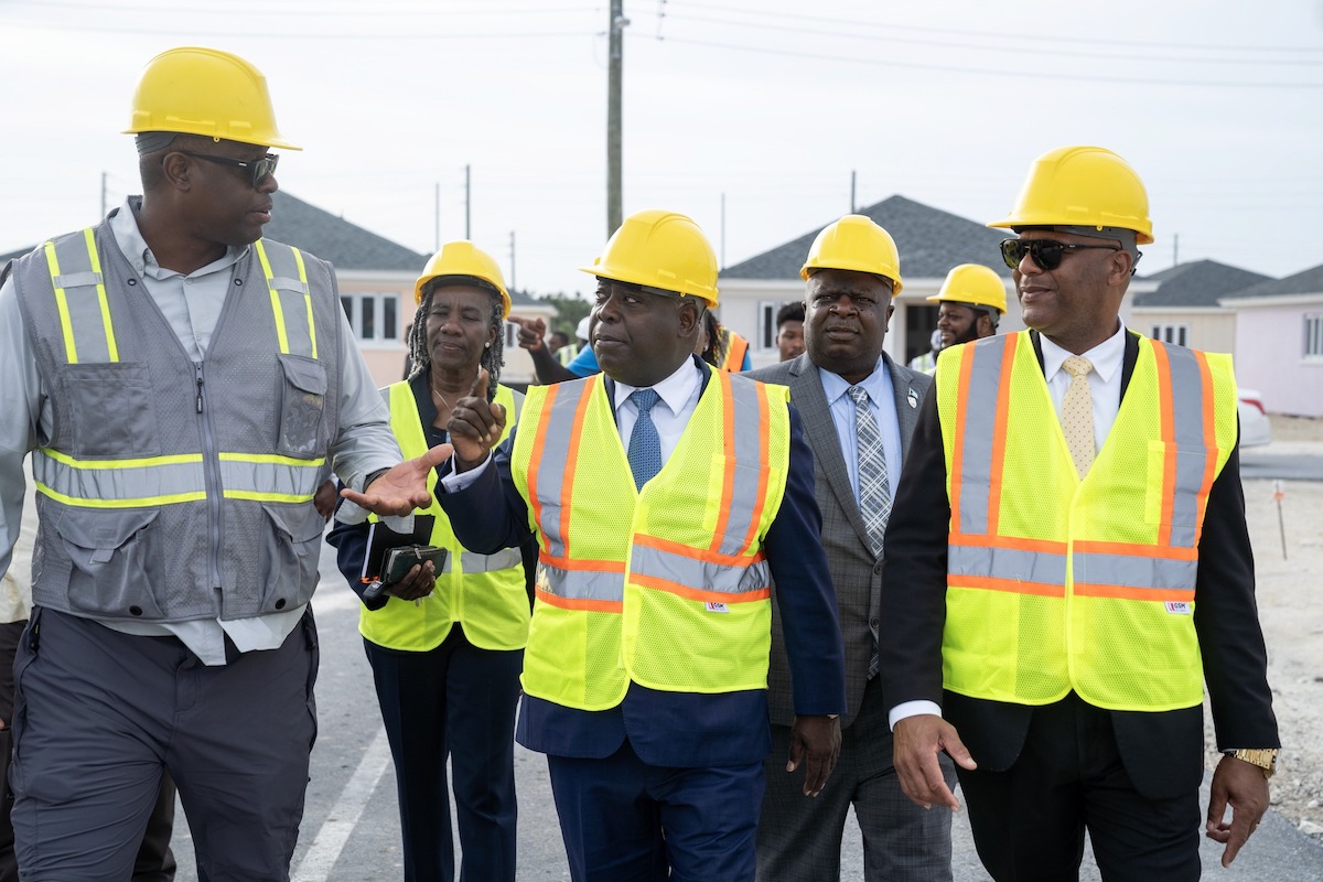 Prime Minister Philip E. Davis (center) and Minister of Housing and Urban Renewal Keith Bell (right) take a tour of the new Renaissance at Carmichael subdivision housing development in New Providence. (Courtesy photo)