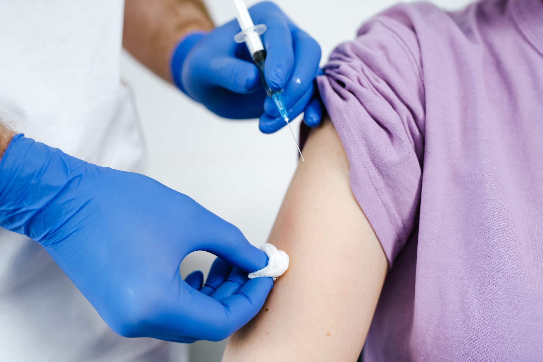 close up shot of a health worker injecting a vaccine on a patient