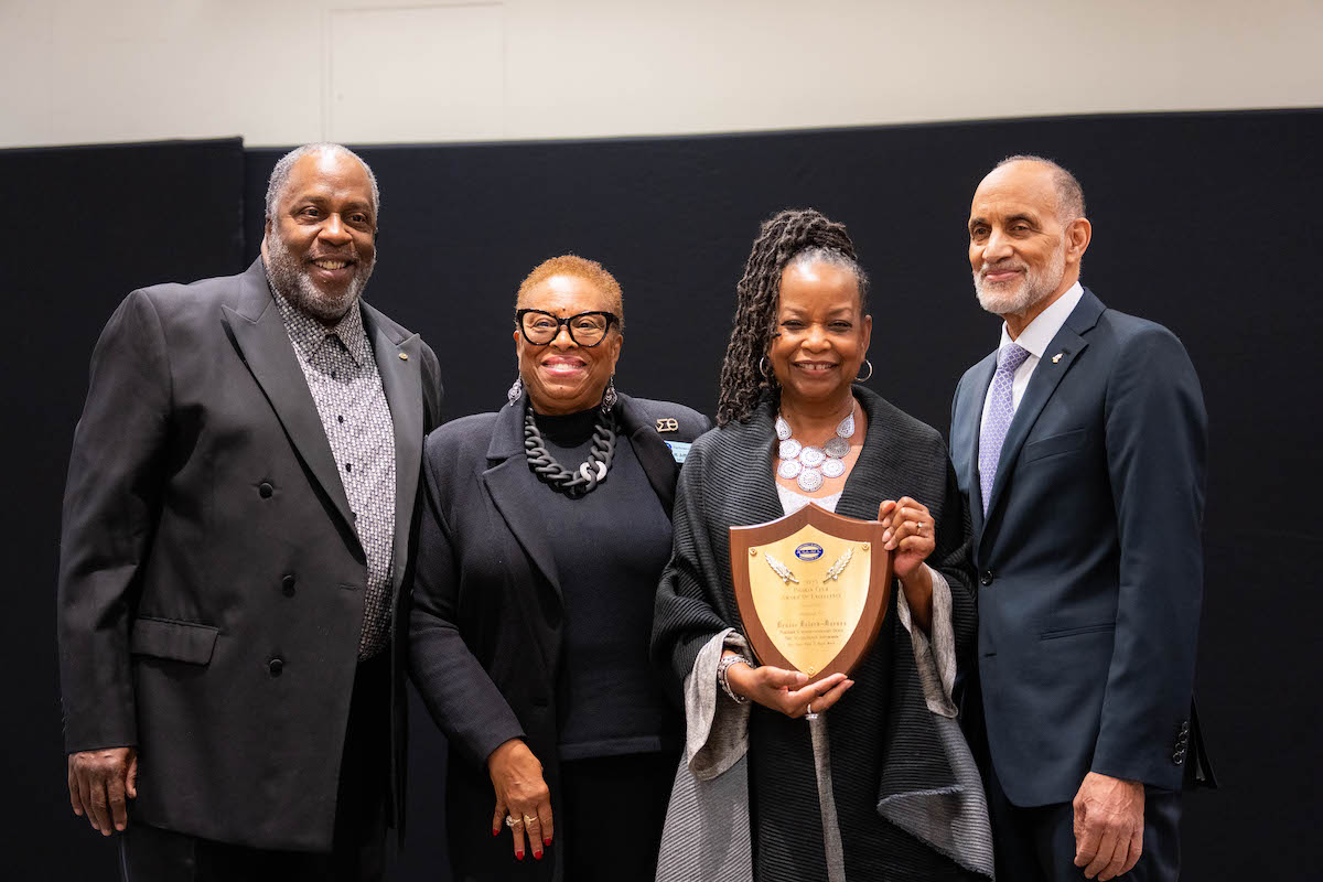 The Pigskin Club of Washington hosted the annual fall banquet awards honoring excellence in sports and leadership in the community. Club President William Chesley, Correspondence Secretary Aona Jefferson, Washington Informer Publisher Denise Rolark Barnes, and event master of ceremonies Bruce Bradford pose for a photo after Rolark Barnes received the Award of Excellence. (Abdullah Konte/The Washington Informer)