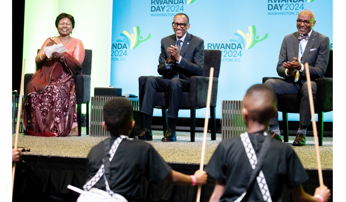 Rwandan President Paul Kagame, Mathilde Mukantabana, Rwanda's ambassador to the United States, and Yehoyada Mbangukira, president of U.S. Rwandan Community Abroad applaud for young dancers during Rwanda Day in Washington, D.C. (Courtesy of Village Urugwiro)