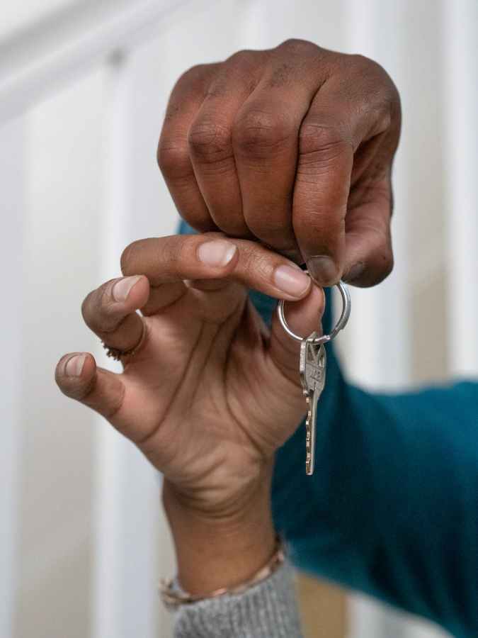 people holding a key