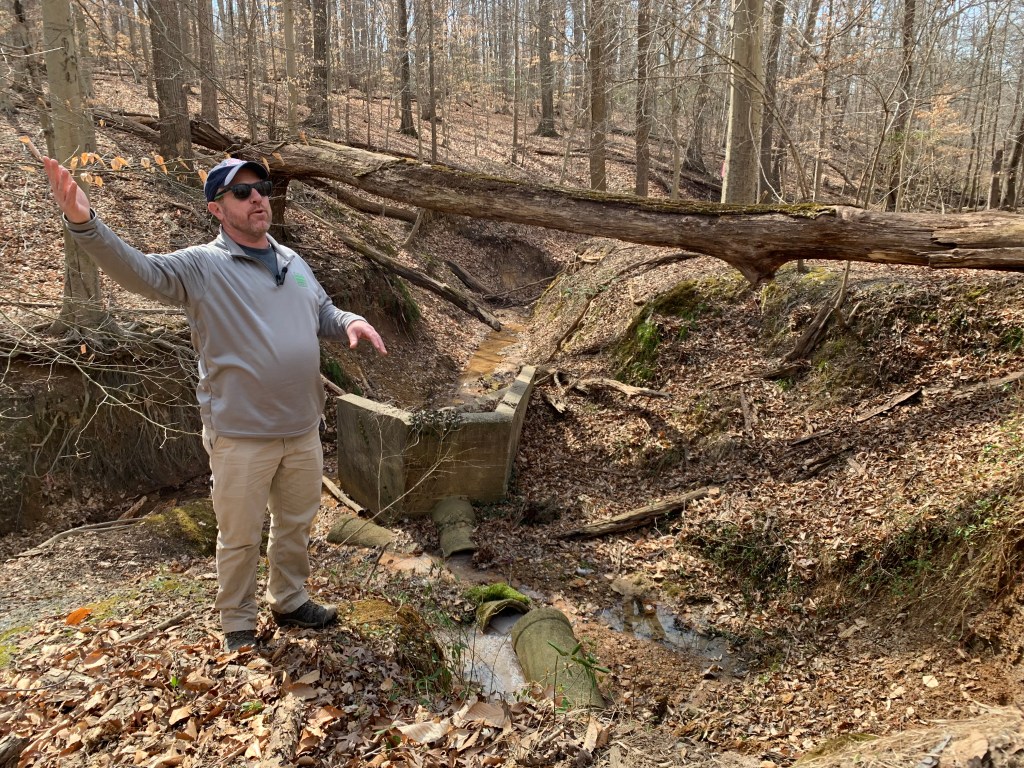 Josh Burch, DOEE’s stream protection specialist, describes the problem to the group. “It's like taking a firehose and pointing it at sand,” he explained. “When it rains out, the Anacostia River looks like coffee with milk in it, and it’s all that sediment stirred up.” (Kayla Benjamin/The Washington Informer)