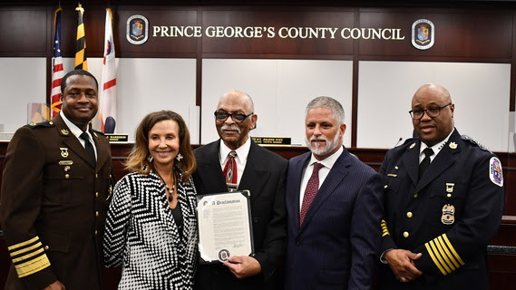 Prince George's County Police Chief Malik Aziz, Sheriff John D.B. Carr and the county council honor Alonzo Black, who was elected as the county's first Black sheriff in 1998. (Courtesy of Prince George's County Council)