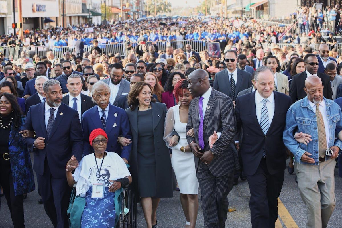 Vice President Kamala Harris (center, in blue) walks across the Edmund Pettus Bridge in Selma, Ala., on March 3, 2024, with hundreds of others, including the Rev. Al Sharpton (third from left) and attorney Ben Crump (third from right), in commemoration of the 59th anniversary of the Bloody Sunday voting rights march in 1965. (Courtesy of Vice President Harris via X)