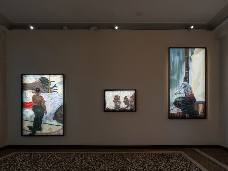 This image captures an exhibition of artworks by Toyin Ojih Odutola. On the left is “Nwanyeruwa (Aba Women’s Rebellion), 2023-2024,” the center is titled “Congregation, 2023,” and on the right is “Onye ututu (Morning Person), 2023.” These pieces seem to explore themes of cultural identity, history, and personal narrative, employing a rich, detailed style.(Courtesy of the Museum of West African Art)