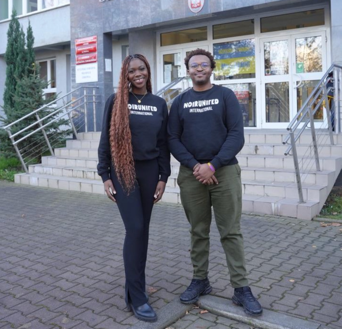 Macire Aribot and Nassim Ashford pose outside the Kyiv Medical School satellite branch in Bytom, Poland, after a student gathering where they distributed 50 laptops and tablets. (Courtesy of NoirUnited)