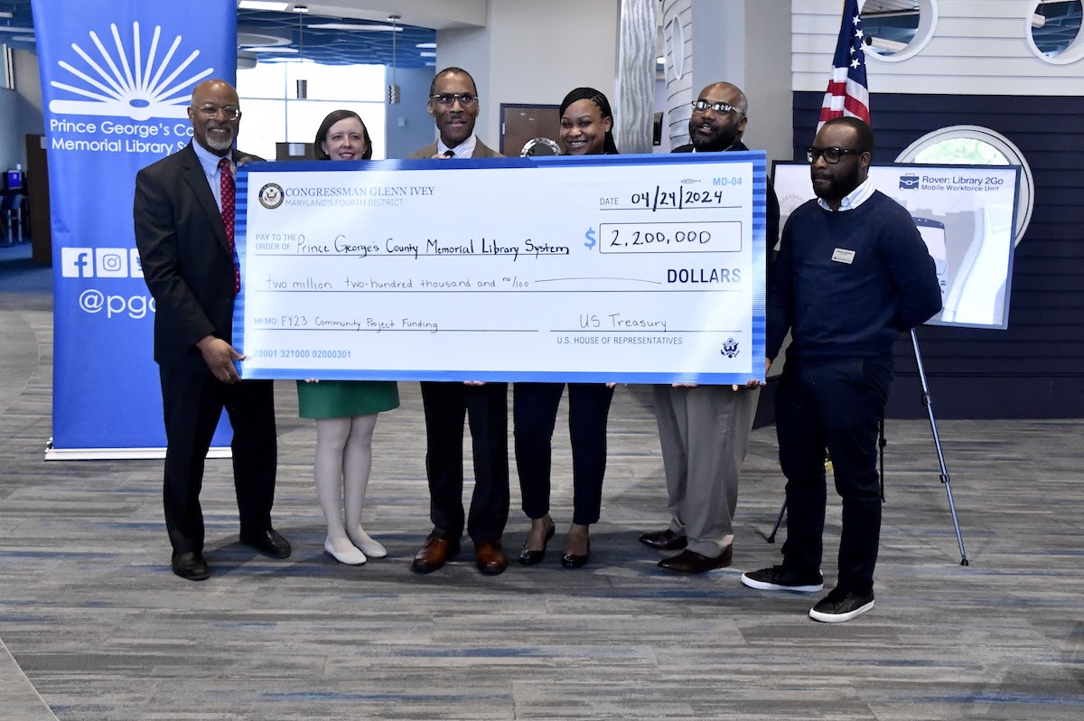 Rep. Glenn Ivey (left) presents a check for Bladensburg Library alongside Prince George’s County Memorial Library System Interim COO for Public Services Megan Sutherland and CEO Dr. Mark Winston, Lauryn Williams, Employ Prince George’s President and CEO, Walter Simmons, and Quemar Rhoden. (Robert R. Roberts/The Washington Informer)