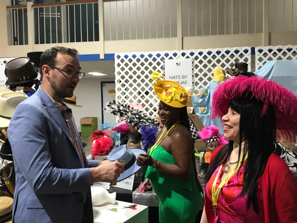 Jedda Queen (front right) speaks with clients in the Grandstand building at Pimlico Race Course in Baltimore during Preakness 149. (Micha Green/The Washington Informer)