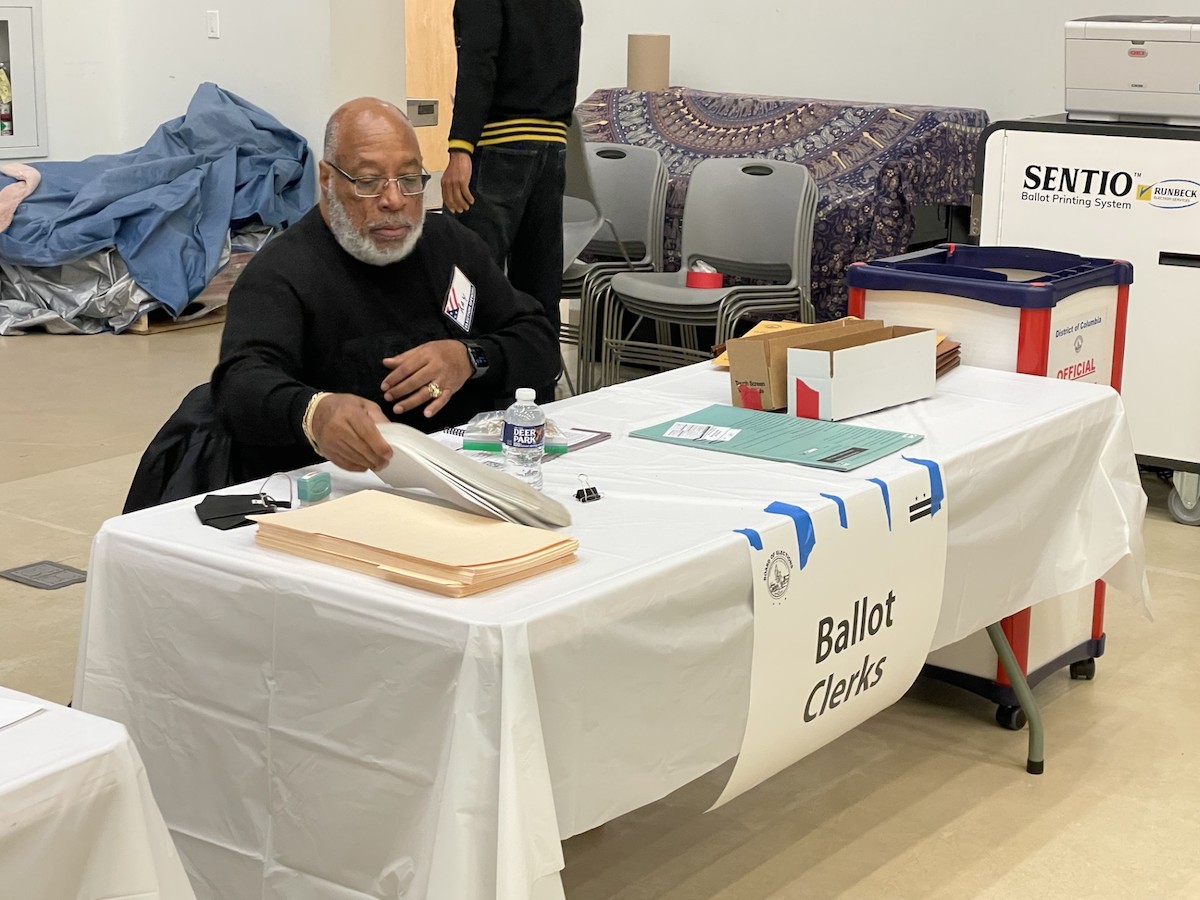 Ray Spears, a member of Alpha Phi Alpha’s Omicron Eta Lambda chapter, examines a ballot at Horace Mann Elementary School in Northwest D.C. (Courtesy of Omicron Eta Lambda chapter)