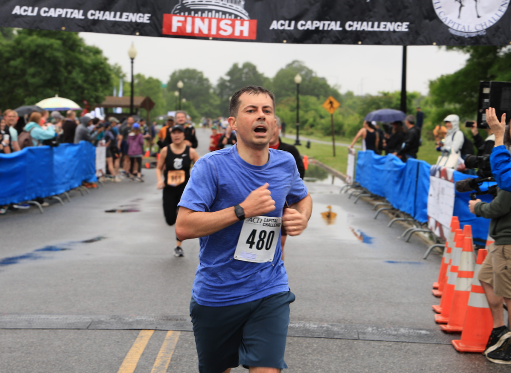 Transportation Secretary Pete Buttigieg crosses the finish line at the ACLI annual race. (Courtesy of ACLI)