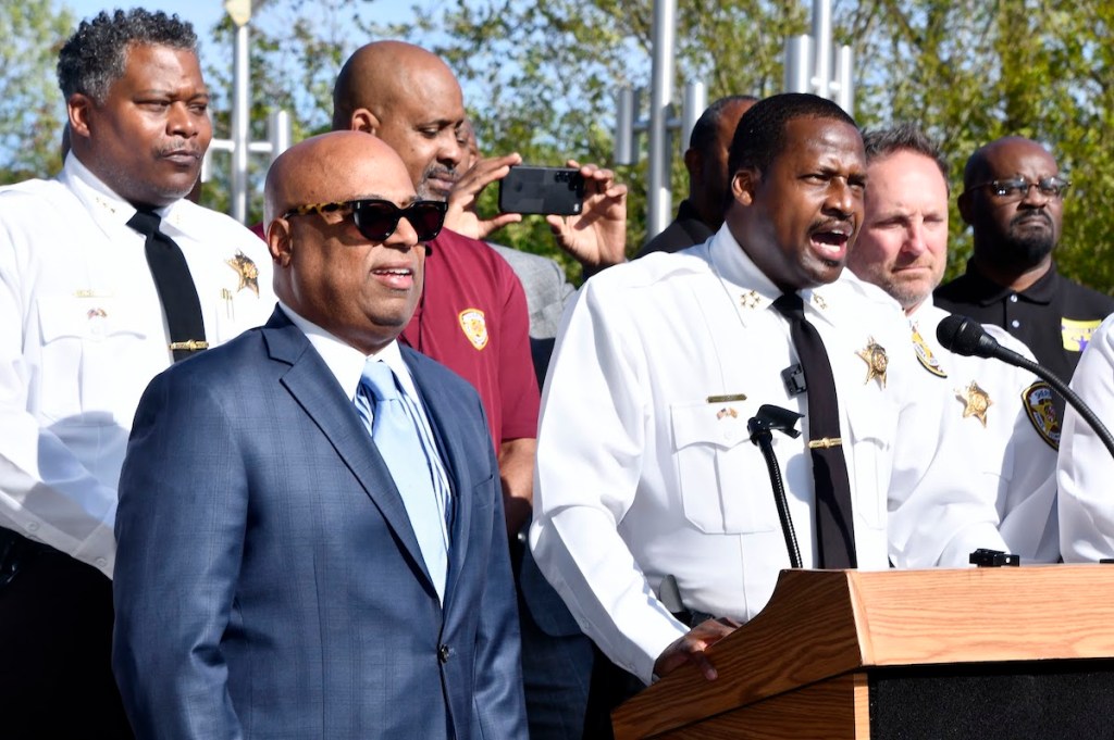 Joined by Council member Calvin Hawkins (left), Sheriff John D.B. Carr (at podium) announces his “Men Who Read” initiative, calling on 100 men in the county to take a pledge that shows reading is both cool and important. (Robert R. Roberts/The Washington Informer)