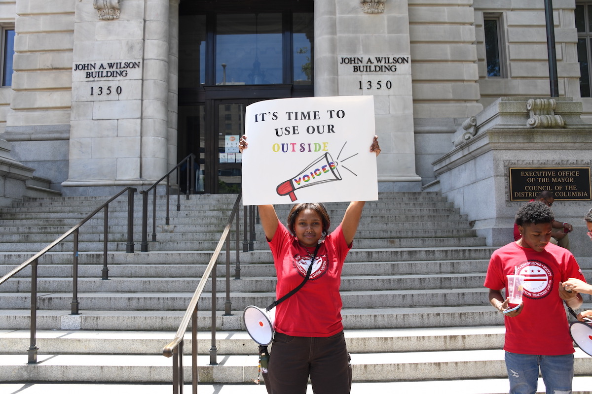 **FILE** A former intern with the Washington Teachers’ Union stands outside of the John A. Wilson Building in 2022. WTU and DCPS are again at odds as a new contract has yet to be finalized, which could result in teachers not receiving salary increases. (WI photo)