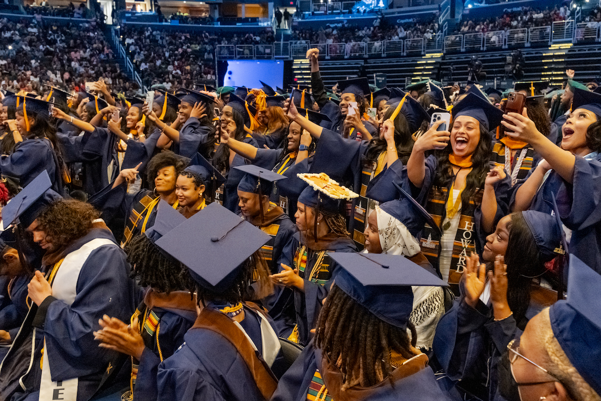 Howard University graduates shout in excitement as each of their departments are officially bestowed their degrees during the 156th commencement convocation. (Ja’Mon Jackson/The Washington Informer)