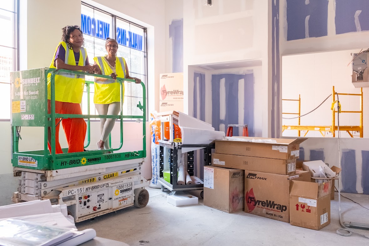 Jaren Hill Lockridge and Nardos Alemayehu of Dreaming Out Loud survey the construction inside the upcoming Marion Barry Avenue Market. (Ja'Mon Jackson/The Washington Informer)