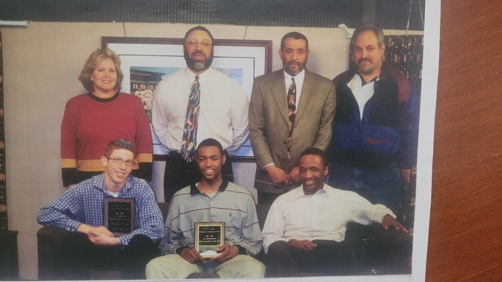 Former NBA player and current Boston Celtics assistant coach Tony Dobbins (seated center) receives an EGOS Player of the Year Award. (Courtesy of EGOS)
