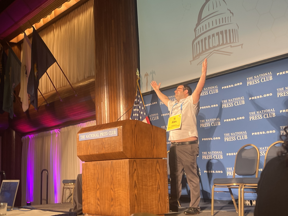 Alex Clearfield of Bloomberg Law holds the trophy for the annual Press vs. Politicians Spelling Bee at the National Press Club. (Ashleigh Fields/The Washington Informer)