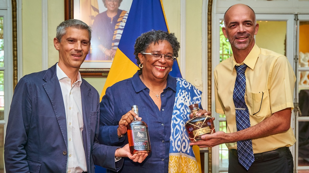 Prime Minister Mia Mottley receives her special edition rums from Antoine Couvreur (left), managing director of Mount Gay Distilleries, and Andrew Hassell, managing director at Stade's West Indies Rum Distillery. (Courtesy photo)