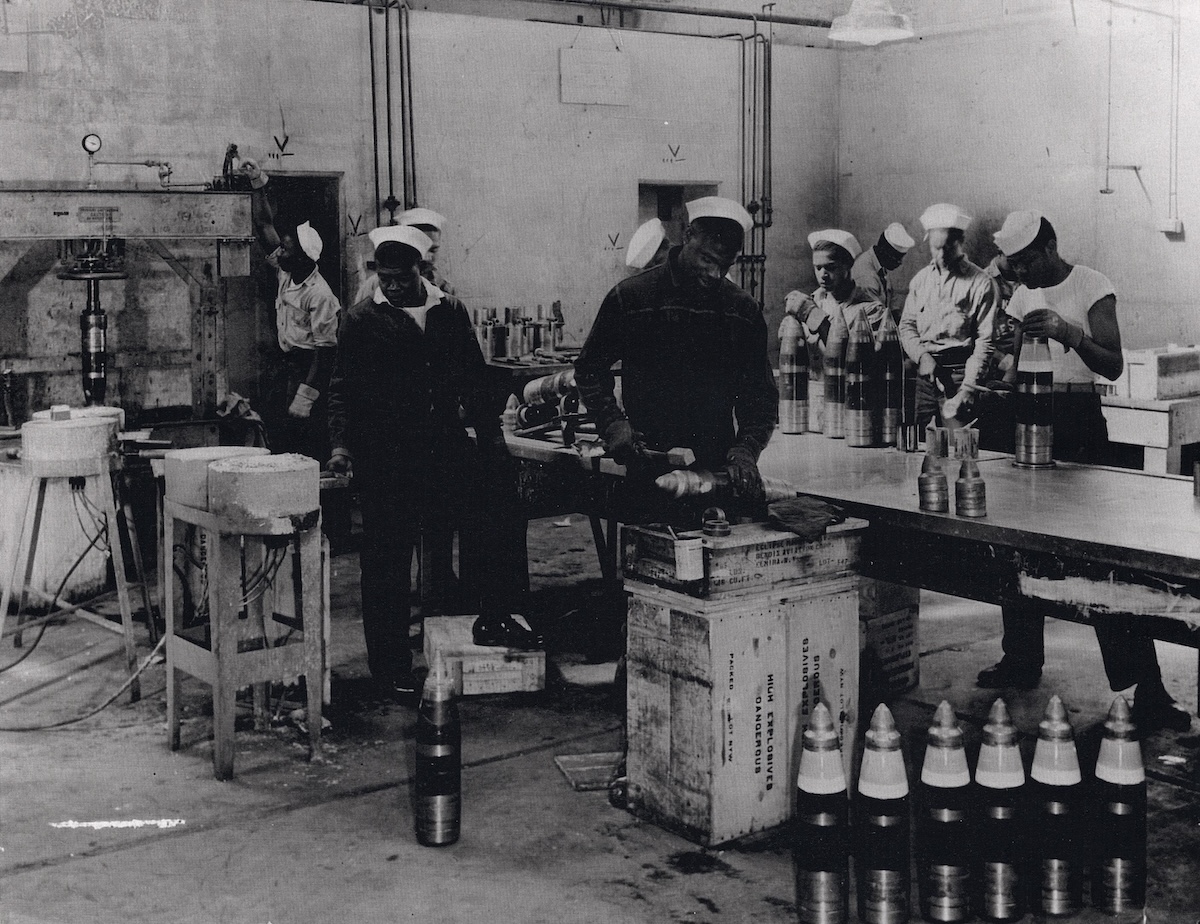 **FILE** African American sailors of an ordnance battalion prepare 5-inch shells for packing at the Port Chicago Naval Magazine in 1943. (U.S. Navy via Wikimedia Commons)